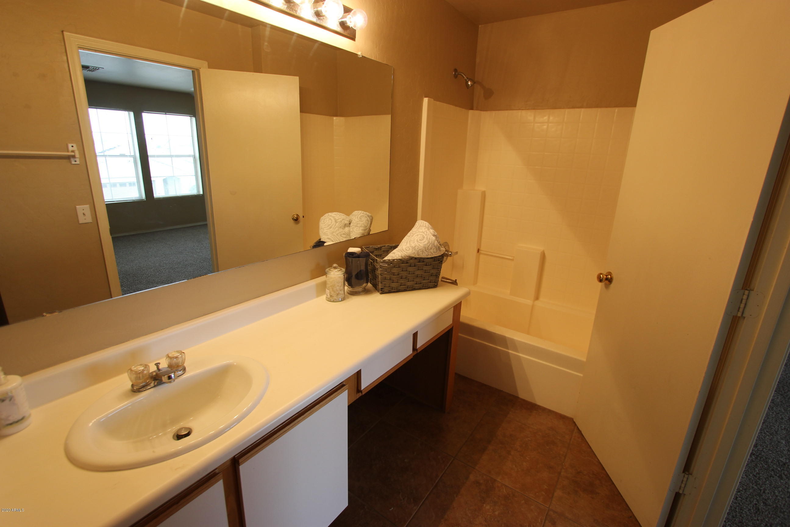 3125 West Fremont Rd. Phoenix, AZ 85041 - Photo 25 of 33 a bathroom with a granite countertop sink and a mirror