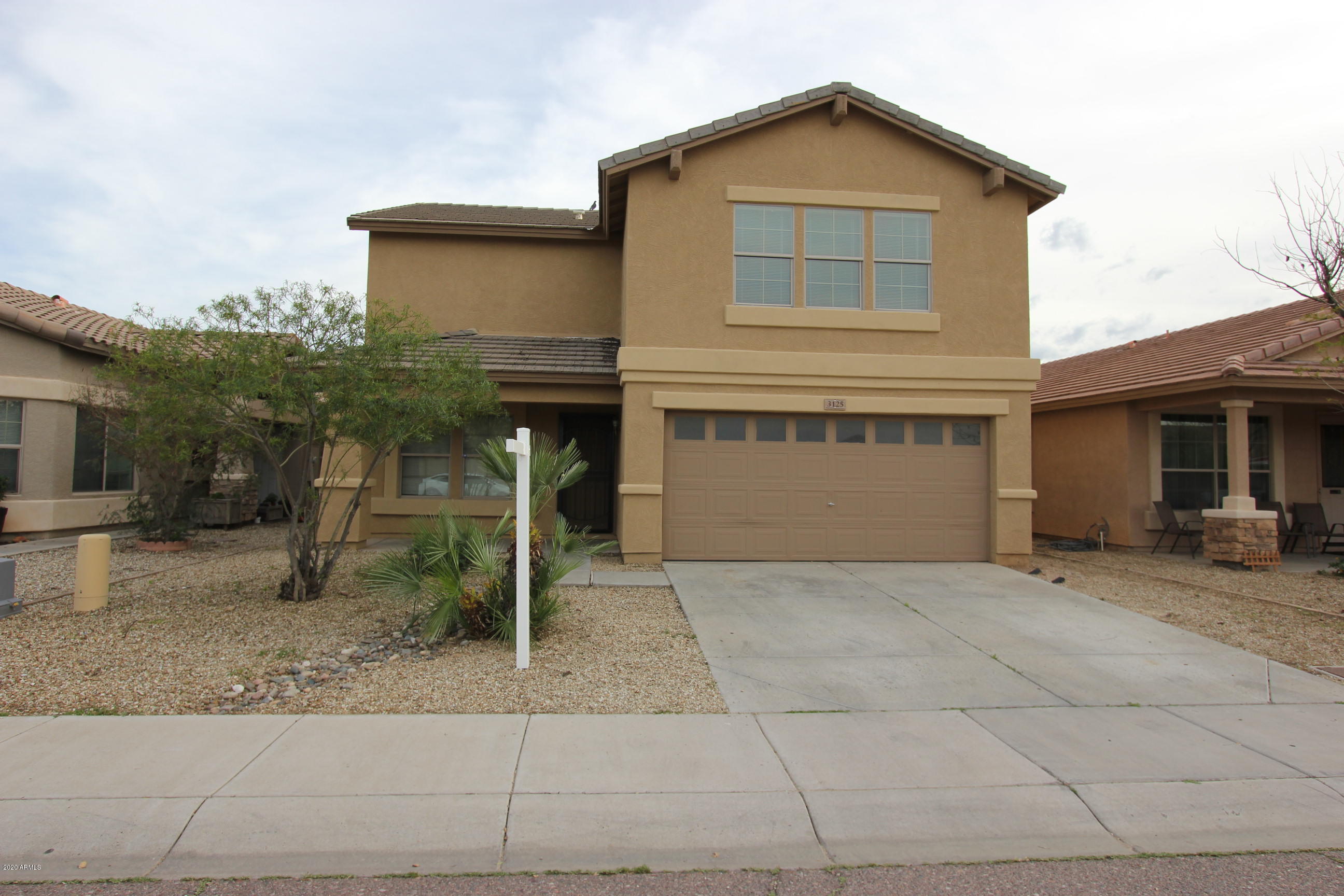3125 West Fremont Rd. Phoenix, AZ 85041 - Photo 32 of 33 a front view of a house with garden