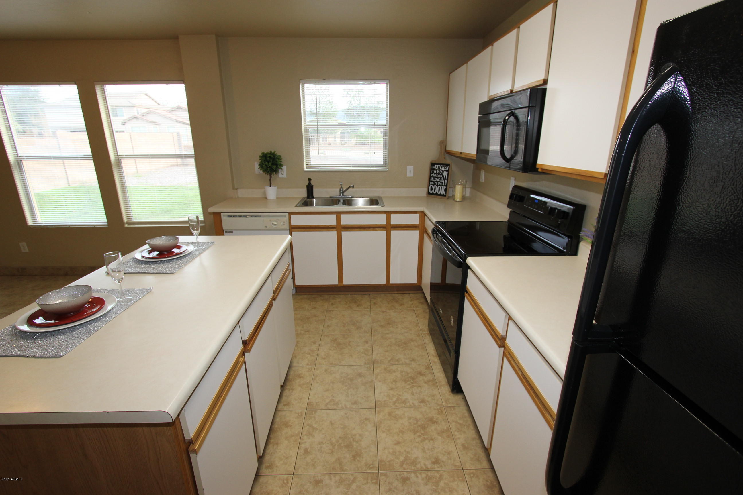 3125 West Fremont Rd. Phoenix, AZ 85041 - Photo 5 of 33 a kitchen that has a sink and a stove in it