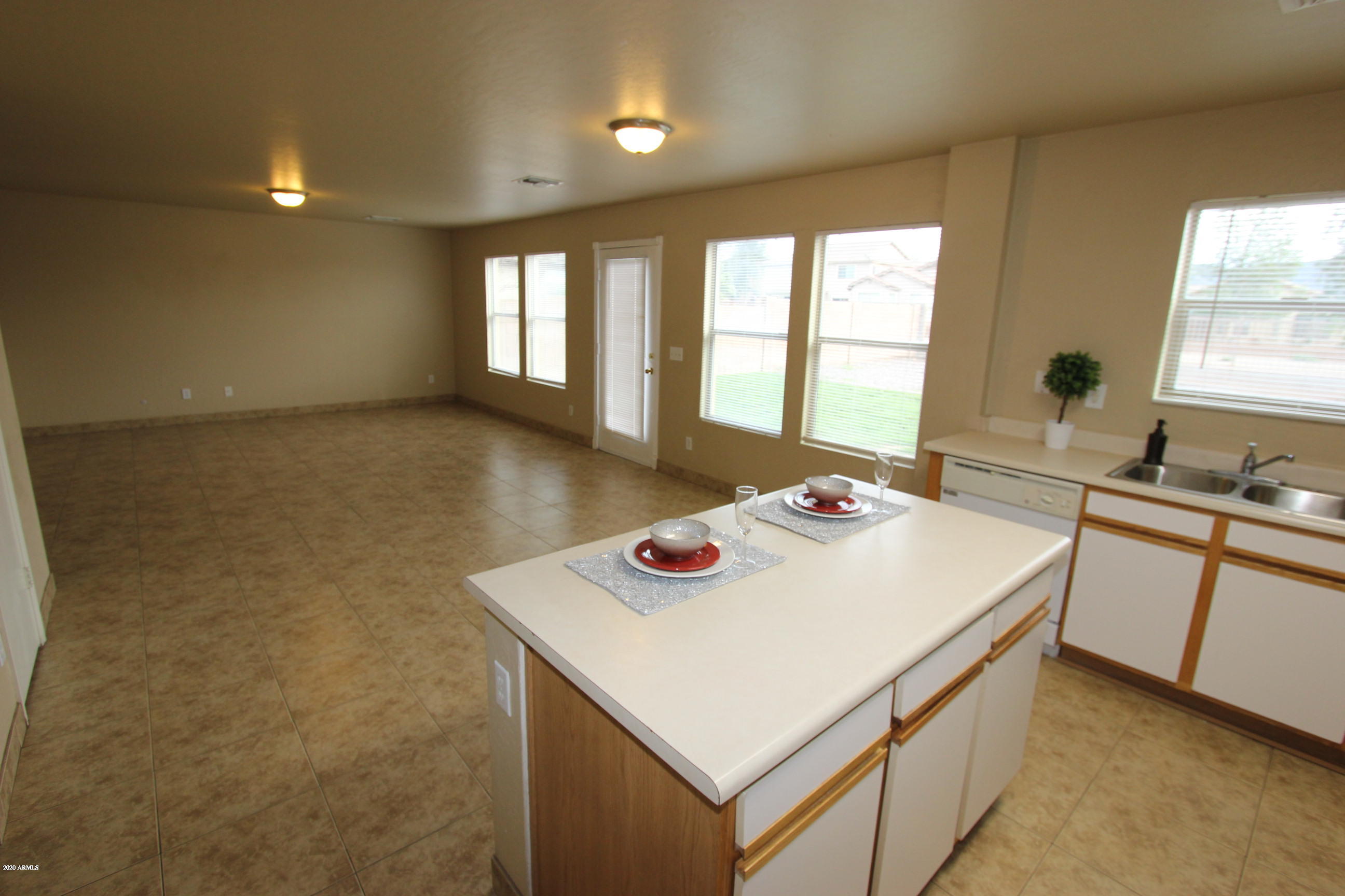 3125 West Fremont Rd. Phoenix, AZ 85041 - Photo 6 of 33 a kitchen that has a sink and a stove with wooden floor