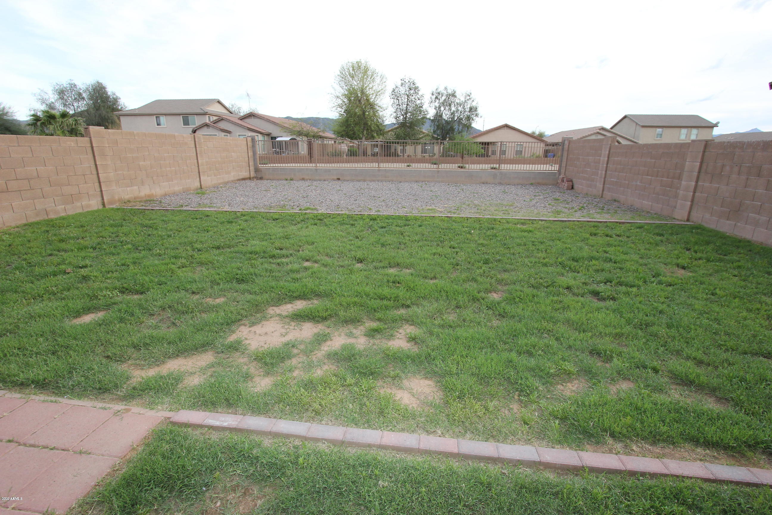 3125 West Fremont Rd. Phoenix, AZ 85041 - Photo 9 of 33 a view of yard with large tree and wooden fence
