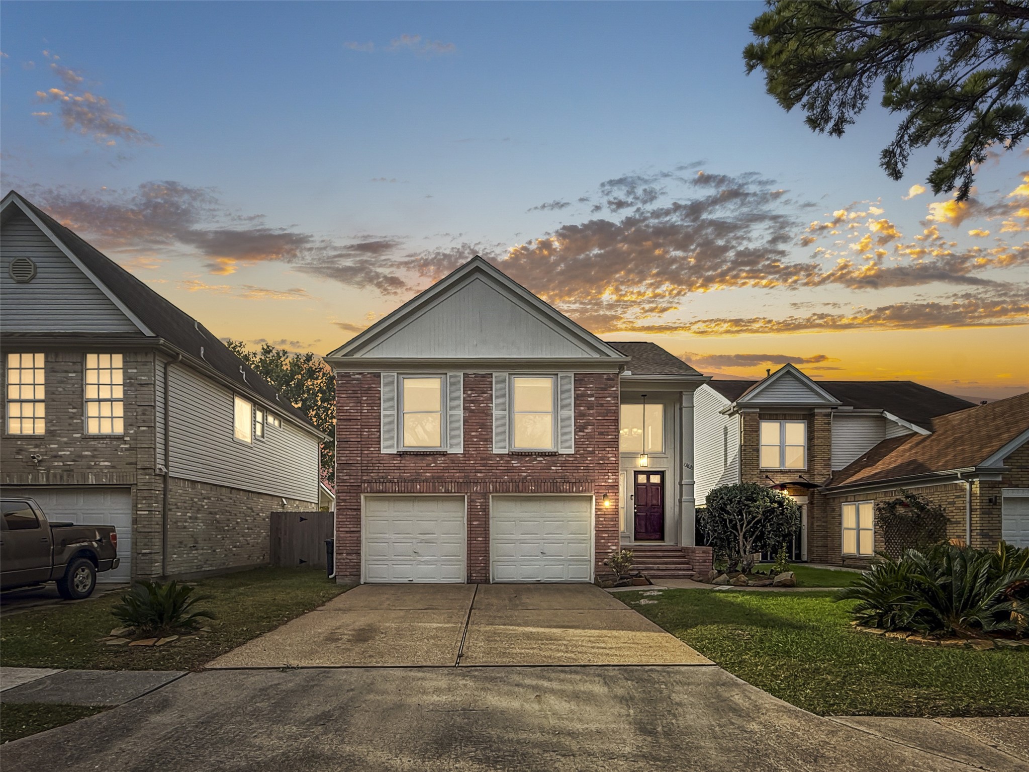13635 Repa Lane Houston, TX 77014 - Photo 1 of 50 Welcome to this lovely two-story brick home with a double garage, in Sablechase. The house features a well-maintained lawn and a welcoming entrance. The evening sky adds a warm backdrop to the property.