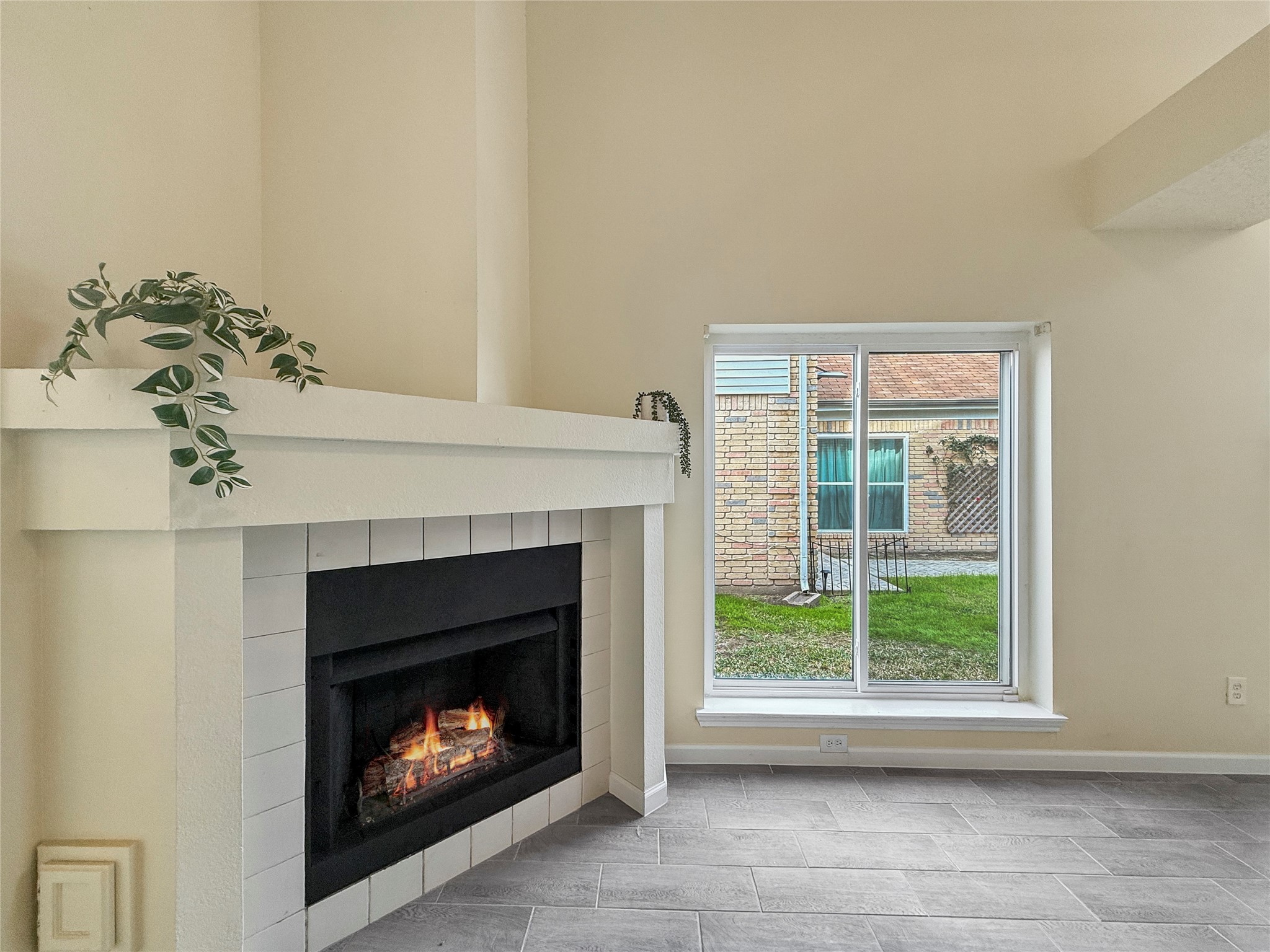 13635 Repa Lane Houston, TX 77014 - Photo 12 of 49 The fireplace is at the heart of the home. Here's nice view of the fireplace and one of the large, newer windows of the home making this home light, and relatively energy efficient.