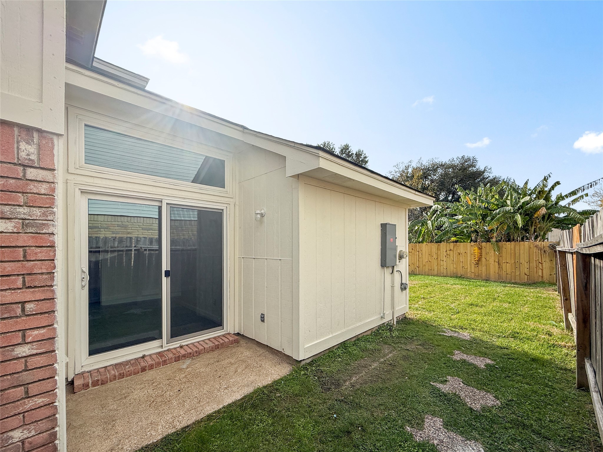 13635 Repa Lane Houston, TX 77014 - Photo 15 of 50 This photo shows a small patio area on the side of the home. From there you can easily reach the large, fully fenced back yard.