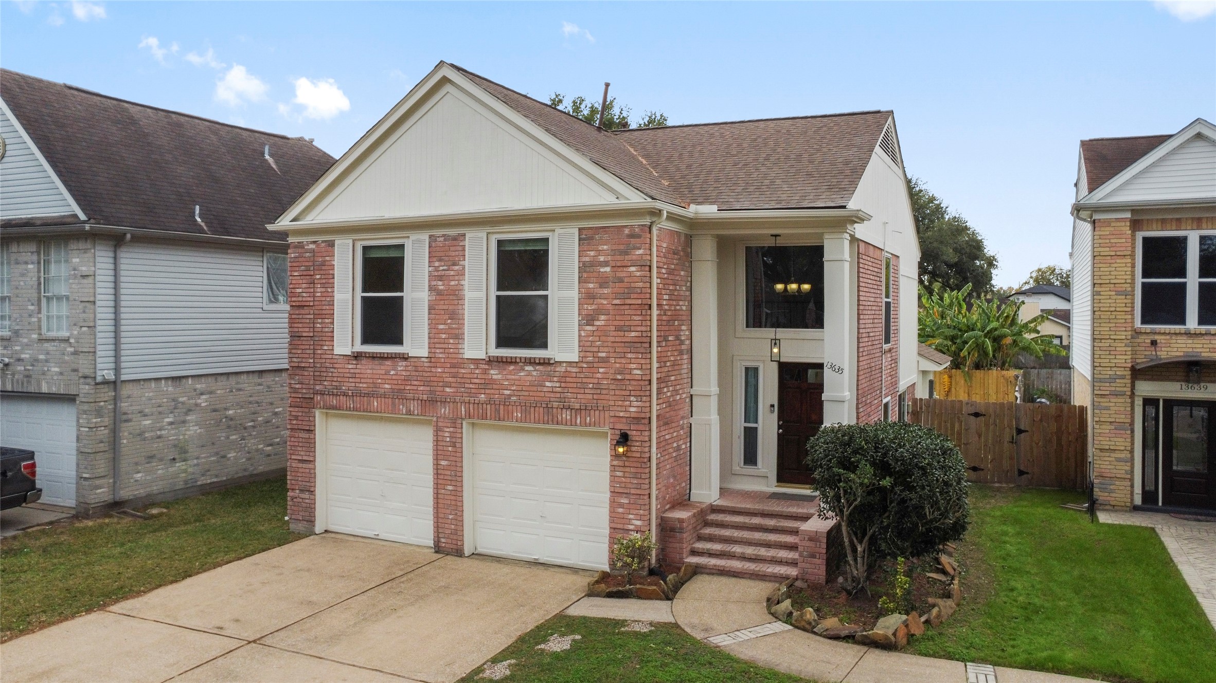 13635 Repa Lane Houston, TX 77014 - Photo 2 of 50 The home has a welcoming entrance with steps leading to a covered porch and a well-maintained front yard.