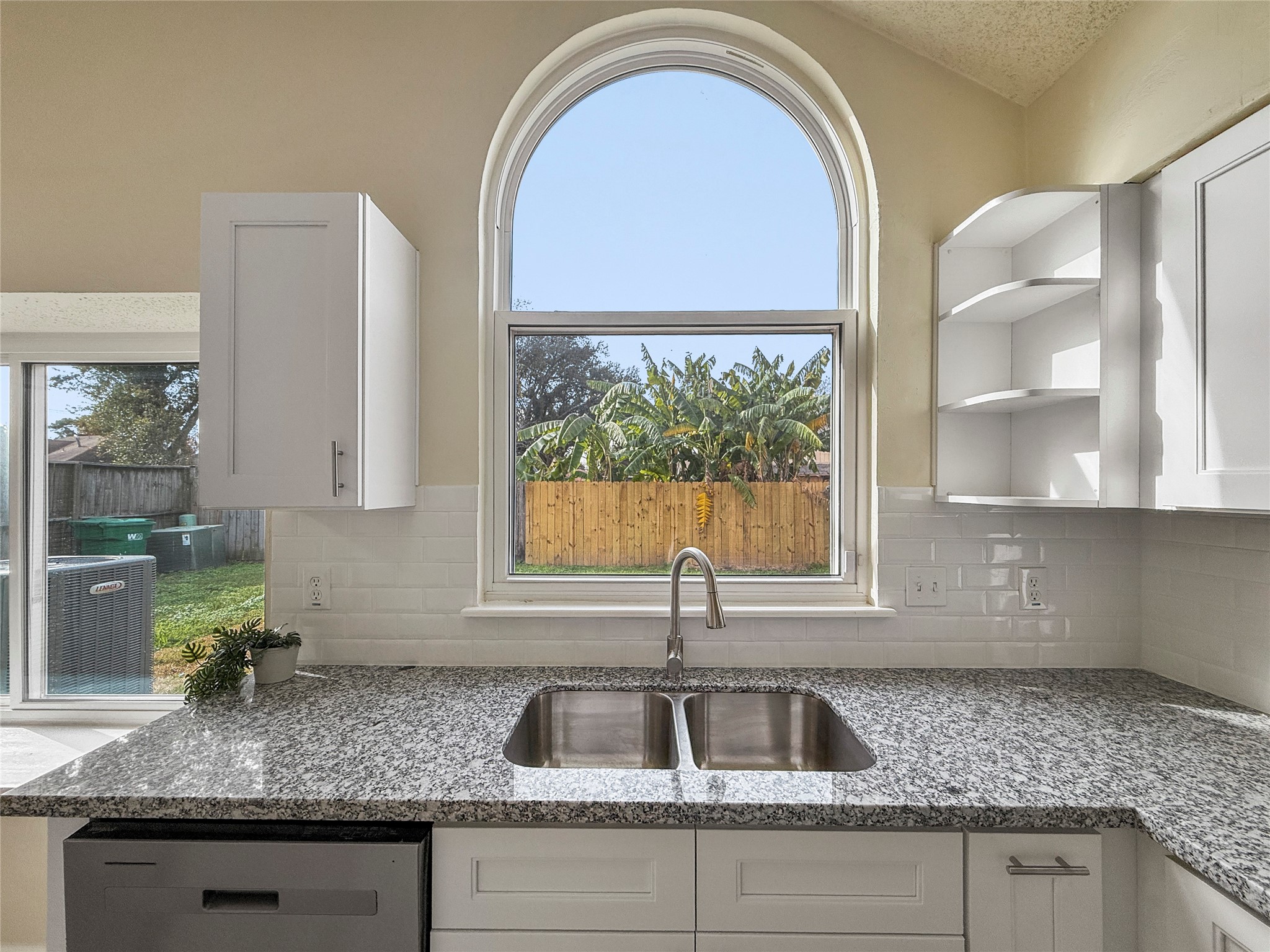 13635 Repa Lane Houston, TX 77014 - Photo 23 of 49 With a large arched window offering a view of the backyard you can keep an eye on what's happening out there while prepping your favorite dishes in the kitchen.