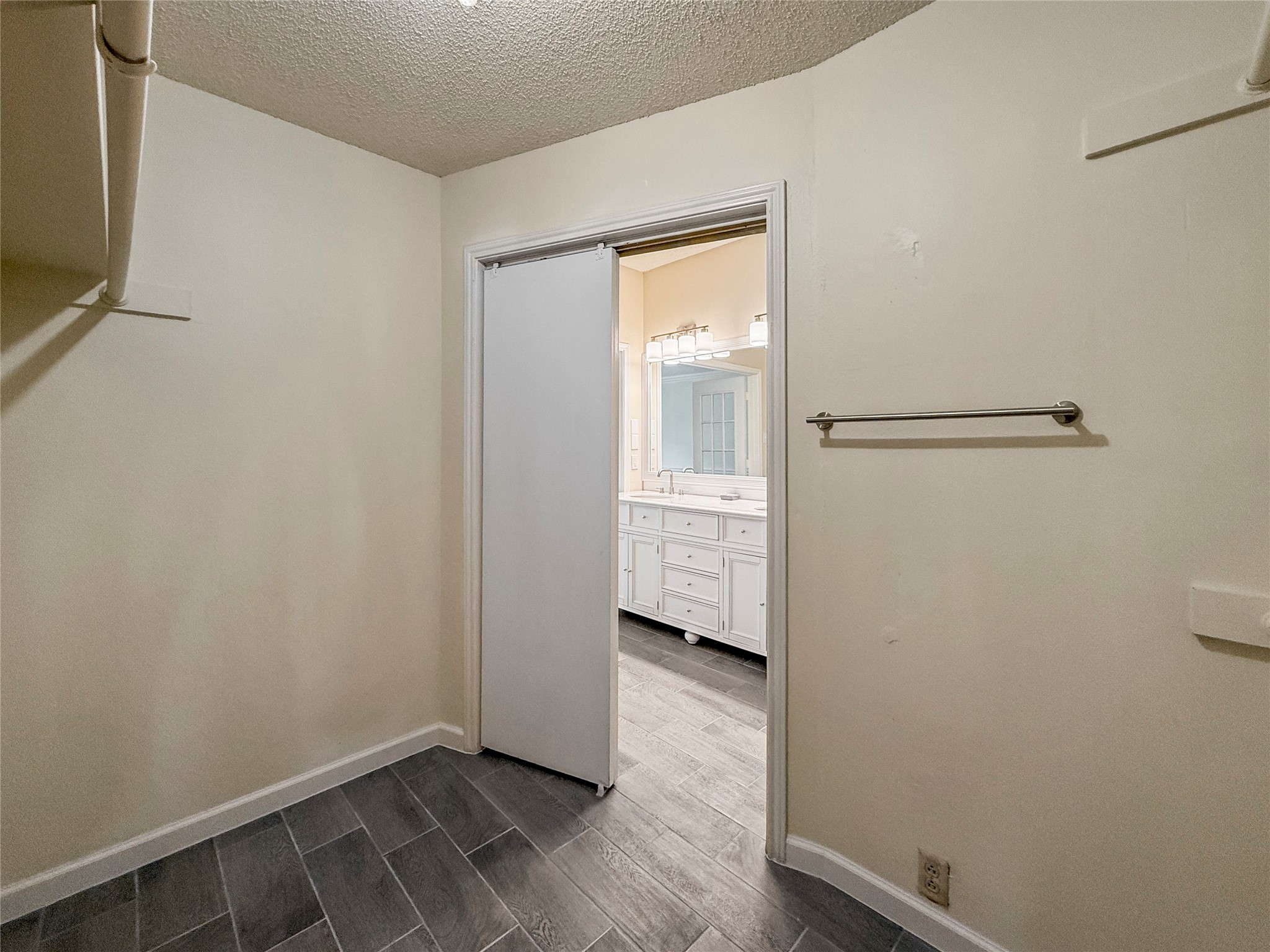 13635 Repa Lane Houston, TX 77014 - Photo 33 of 50 The walk-in closet also has tiled flooring and has hanging rods and shelving for storage.