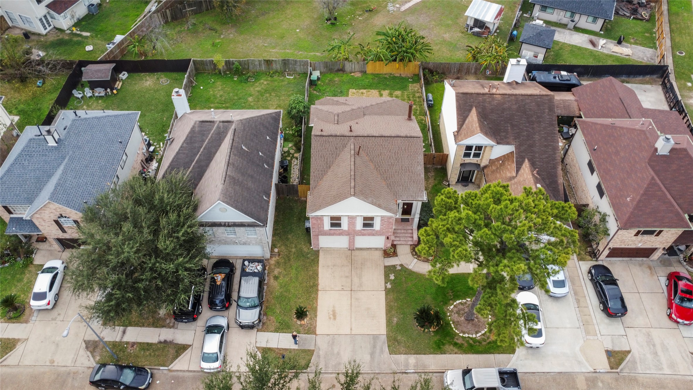 13635 Repa Lane Houston, TX 77014 - Photo 49 of 50 This aerial photo shows a row of suburban homes with driveways and small front yards. All-in-all, a great, spacious, nicely remodeled home, perfect for many potential home owners.
