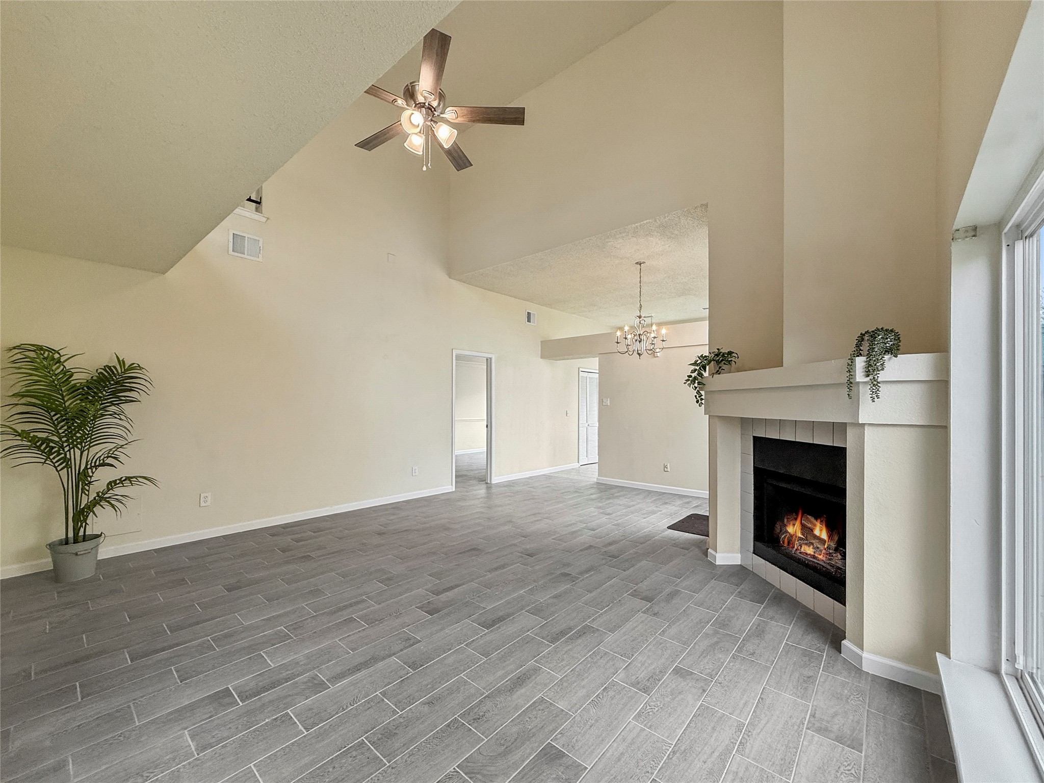 13635 Repa Lane Houston, TX 77014 - Photo 8 of 49 a view of an empty room with wooden floor fireplace and a window