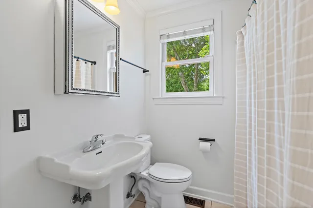 a bathroom with a sink toilet and a mirror
