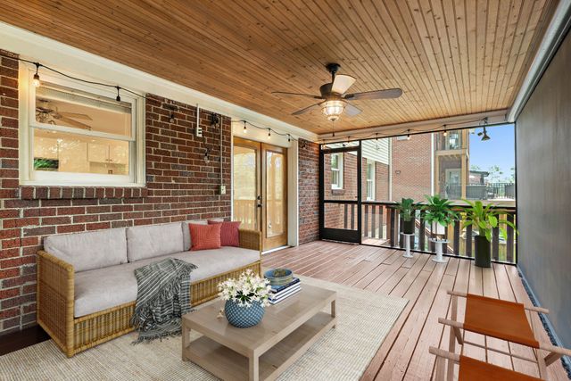 a living room with furniture and a table with wooden floor