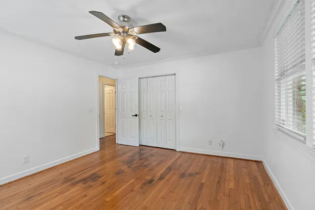 wooden floor in an empty room with a window