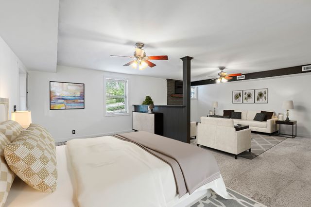 a bedroom with furniture and white walls