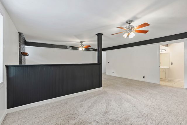a view of a hallway with paintings on the wall