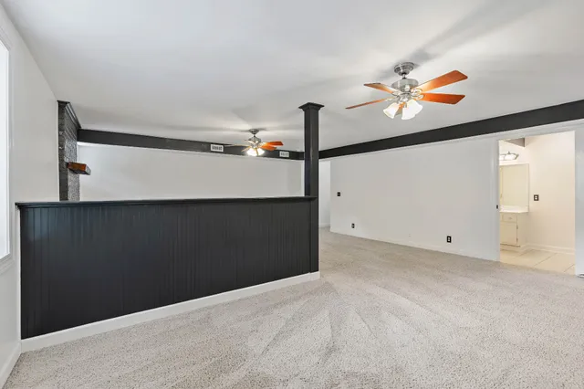 a view of a hallway with paintings on the wall