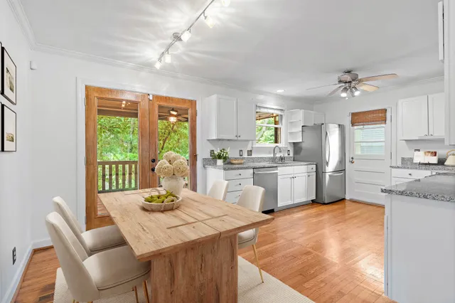 a kitchen with a stove a sink a dining table and chairs
