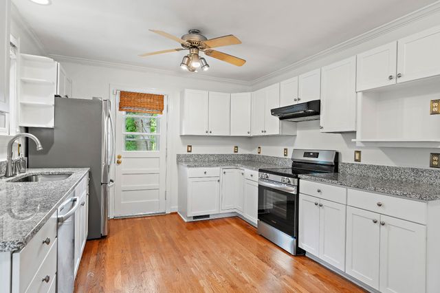 a kitchen with a stove a sink and a refrigerator