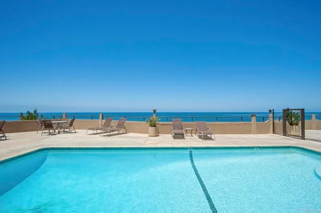 a view of a backyard with table and chairs under an umbrella