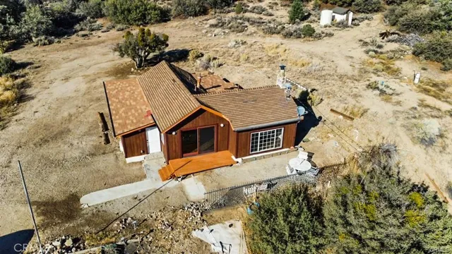 an aerial view of a house with a yard