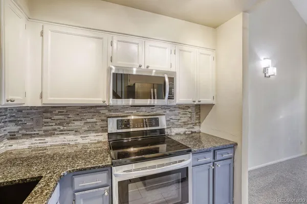 a kitchen with a stove and a microwave