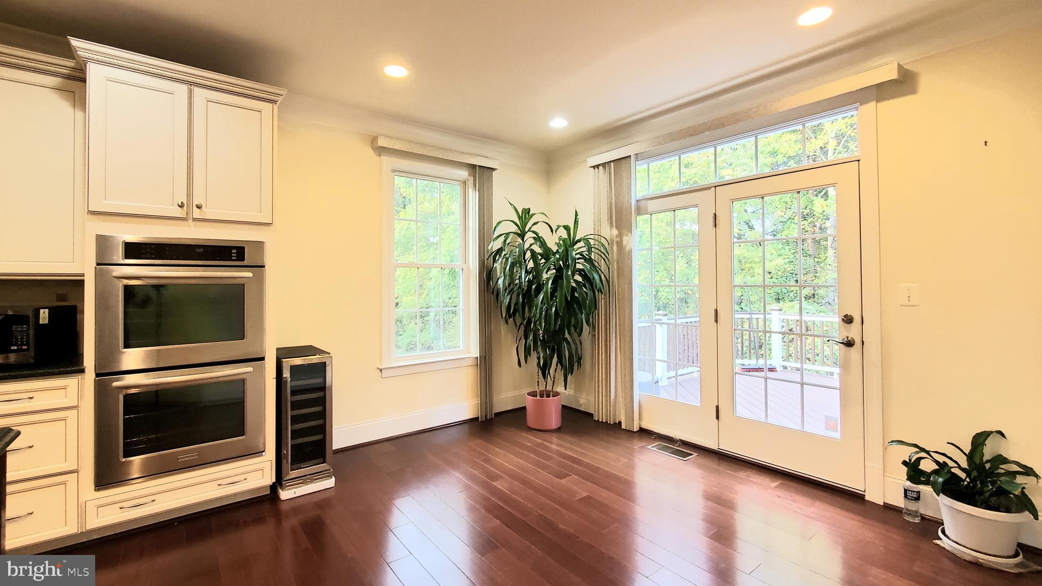 12614 Winter Wren Court Herndon, VA 20171 - Photo 15 of 55 a view of an empty room with wooden floor and a window