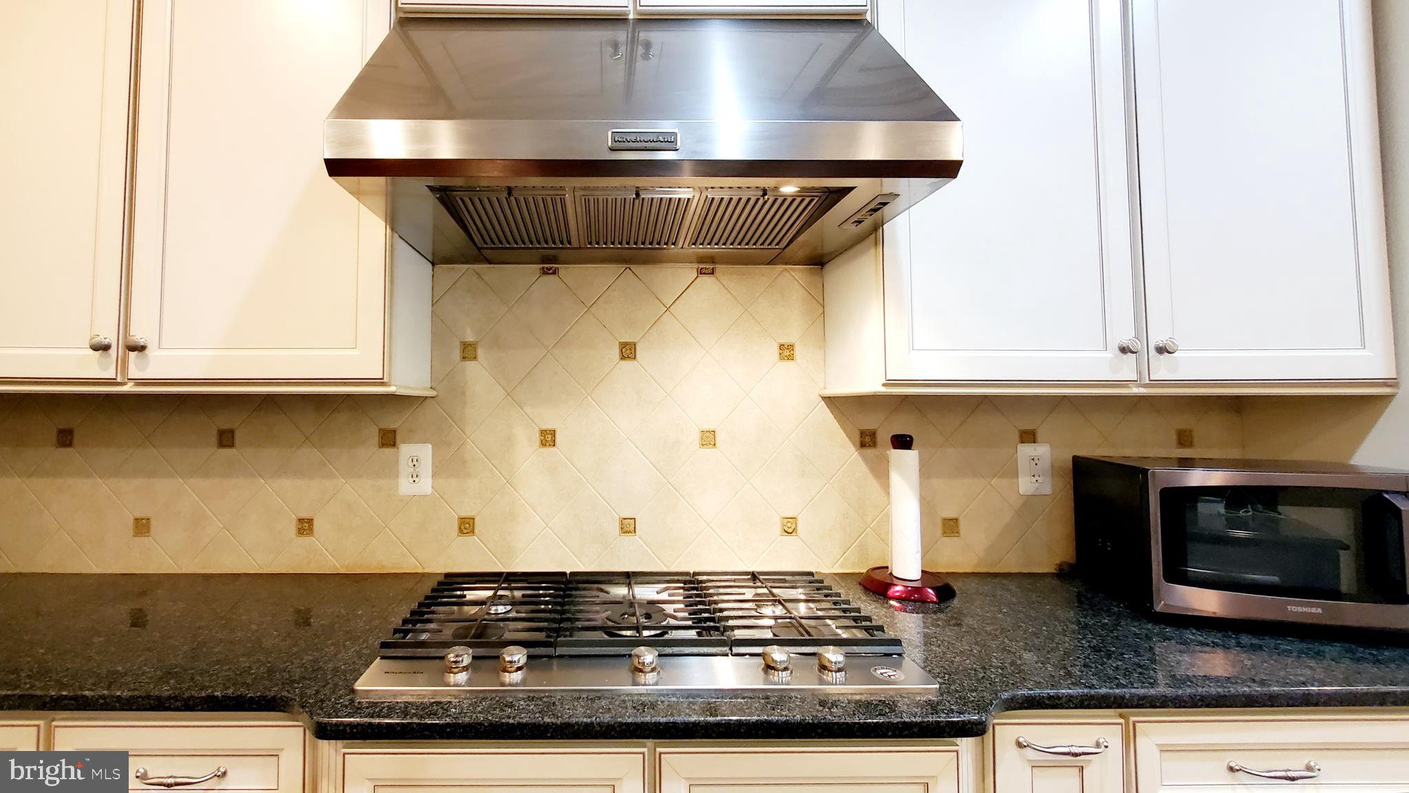 12614 Winter Wren Court Herndon, VA 20171 - Photo 17 of 55 a stove top oven sitting inside of a kitchen