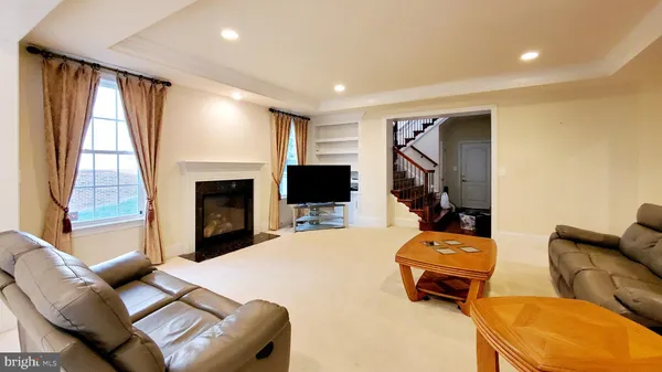 a view of staircase with lots of wooden furniture and windows