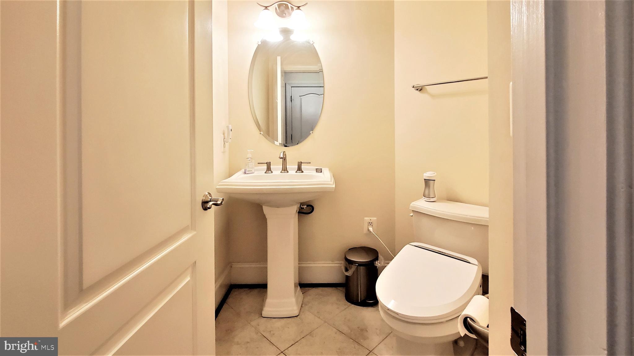 12614 Winter Wren Court Herndon, VA 20171 - Photo 21 of 55 a bathroom with a toilet sink and mirror