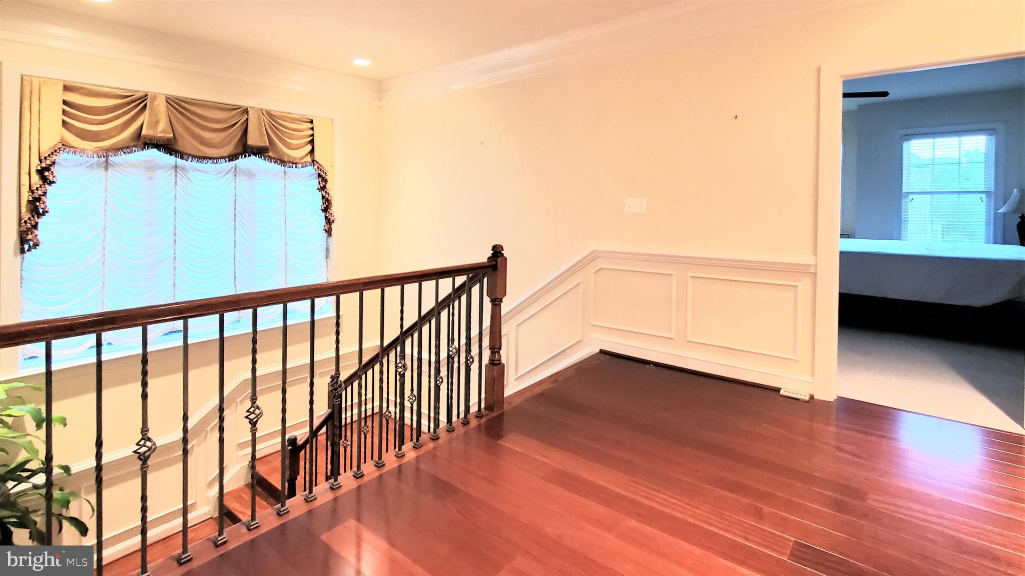 12614 Winter Wren Court Herndon, VA 20171 - Photo 24 of 55 a view of a room with wooden floor and a ceiling fan