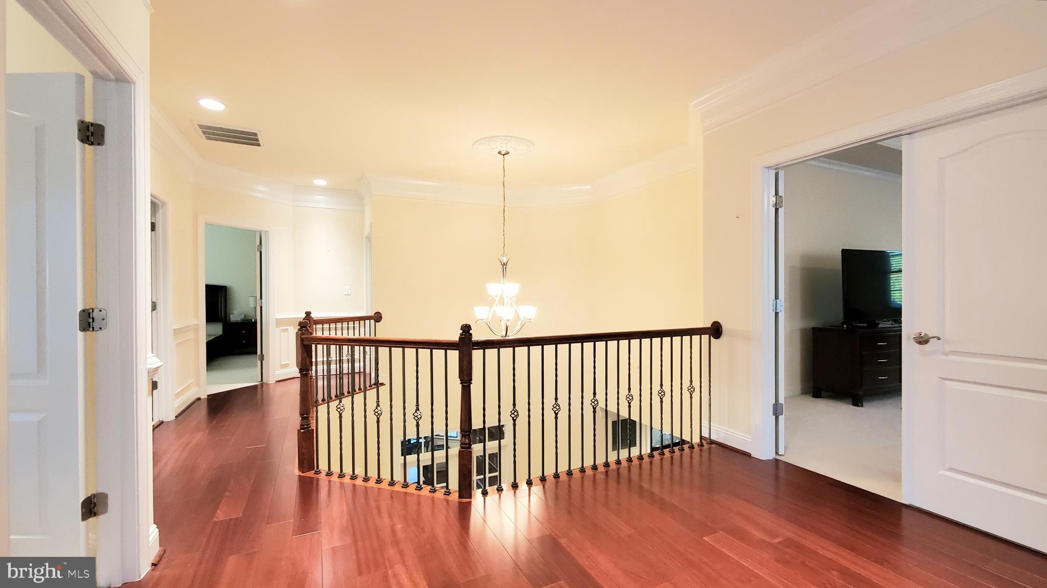 12614 Winter Wren Court Herndon, VA 20171 - Photo 26 of 55 a view of a hallway with wooden floor and a living room