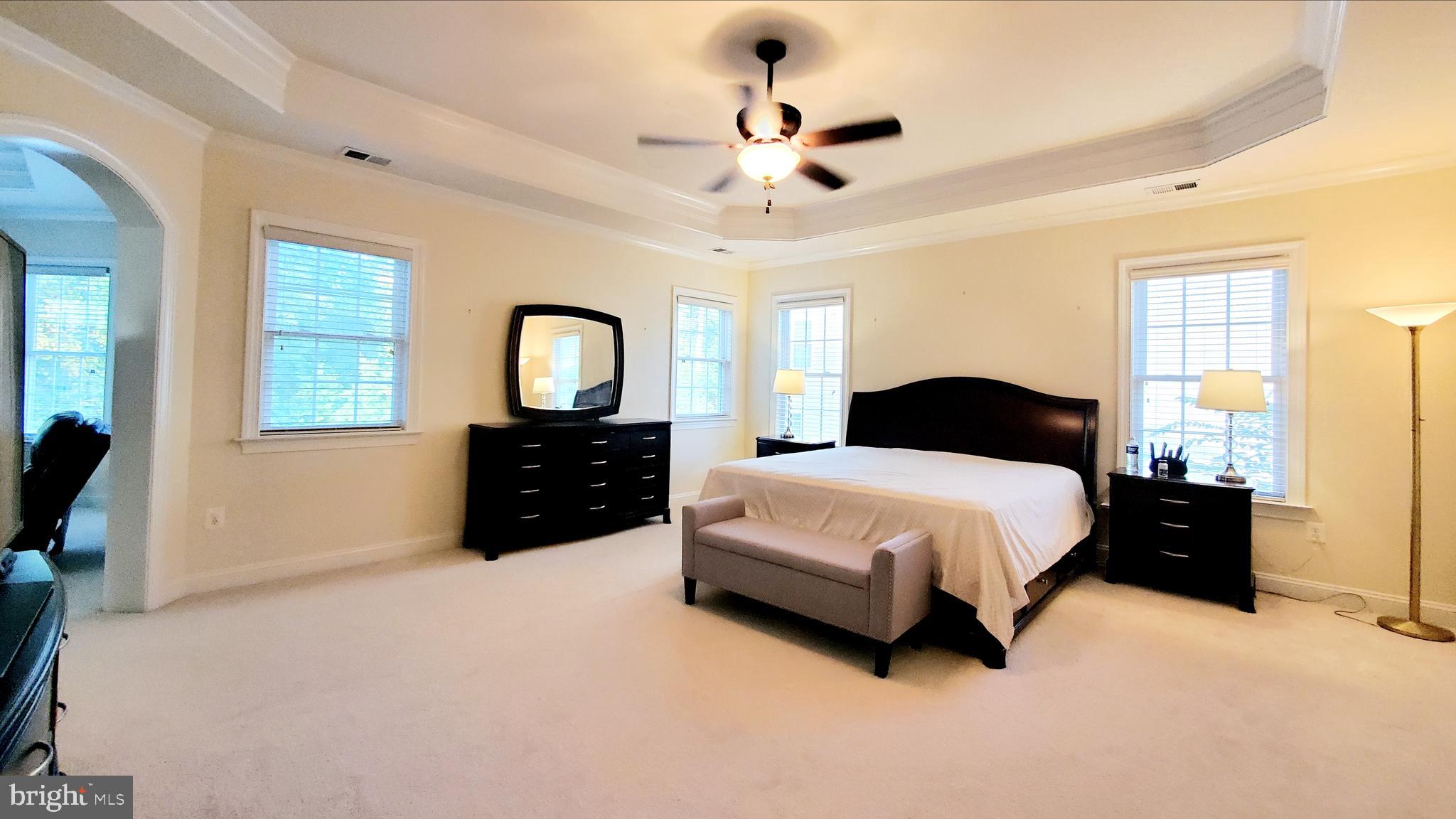 12614 Winter Wren Court Herndon, VA 20171 - Photo 28 of 55 a bedroom with a bed and a chandelier