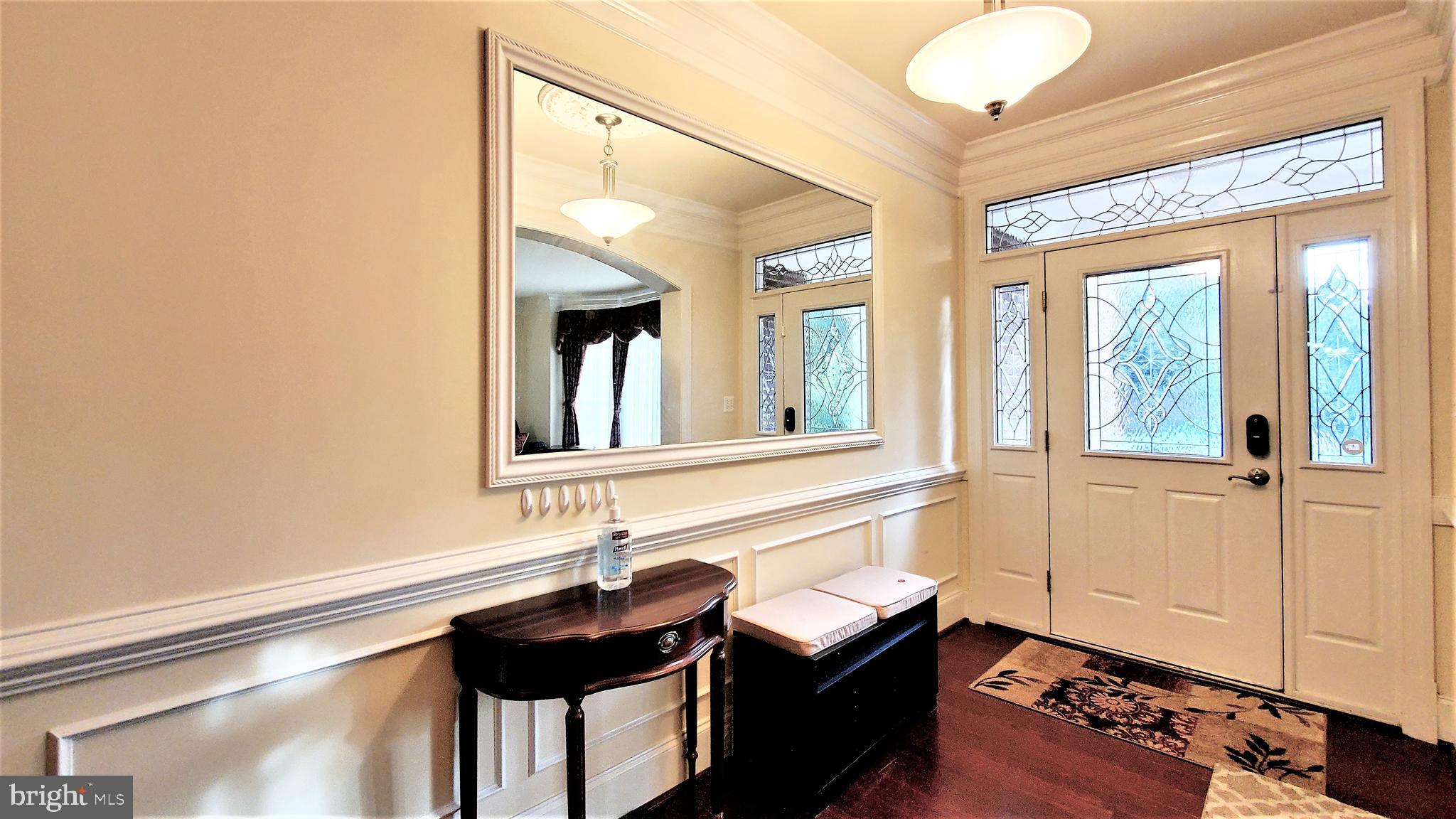 12614 Winter Wren Court Herndon, VA 20171 - Photo 3 of 55 a bathroom with a sink and a large mirror next to a window