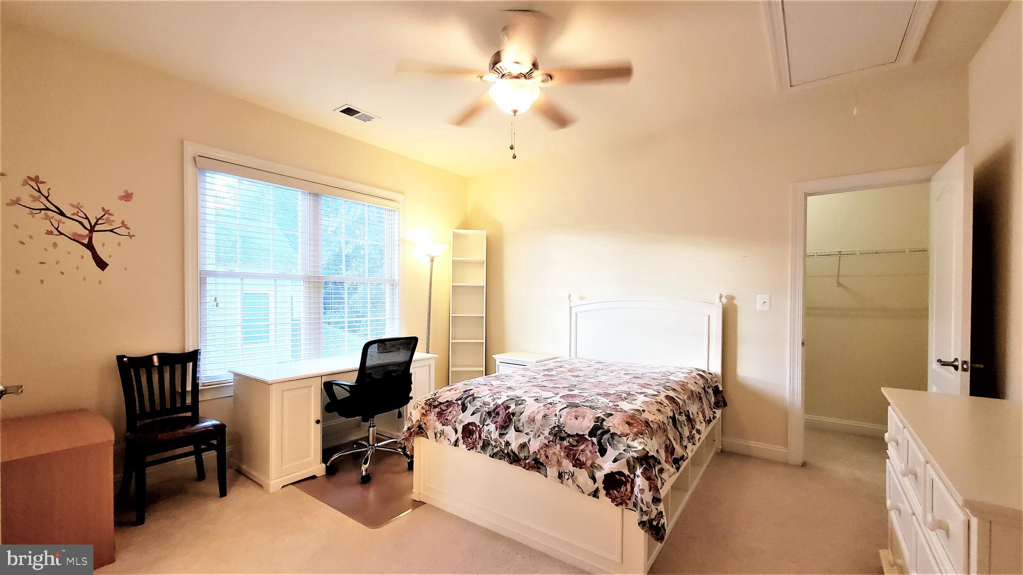 12614 Winter Wren Court Herndon, VA 20171 - Photo 42 of 55 a bedroom with a bed and a chandelier