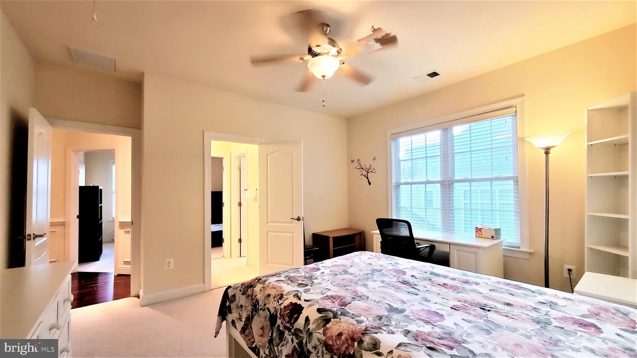 12614 Winter Wren Court Herndon, VA 20171 - Photo 43 of 55 a bedroom with a bed and a chandelier