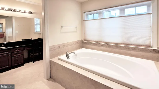 a bathroom with a granite countertop toilet sink and mirror