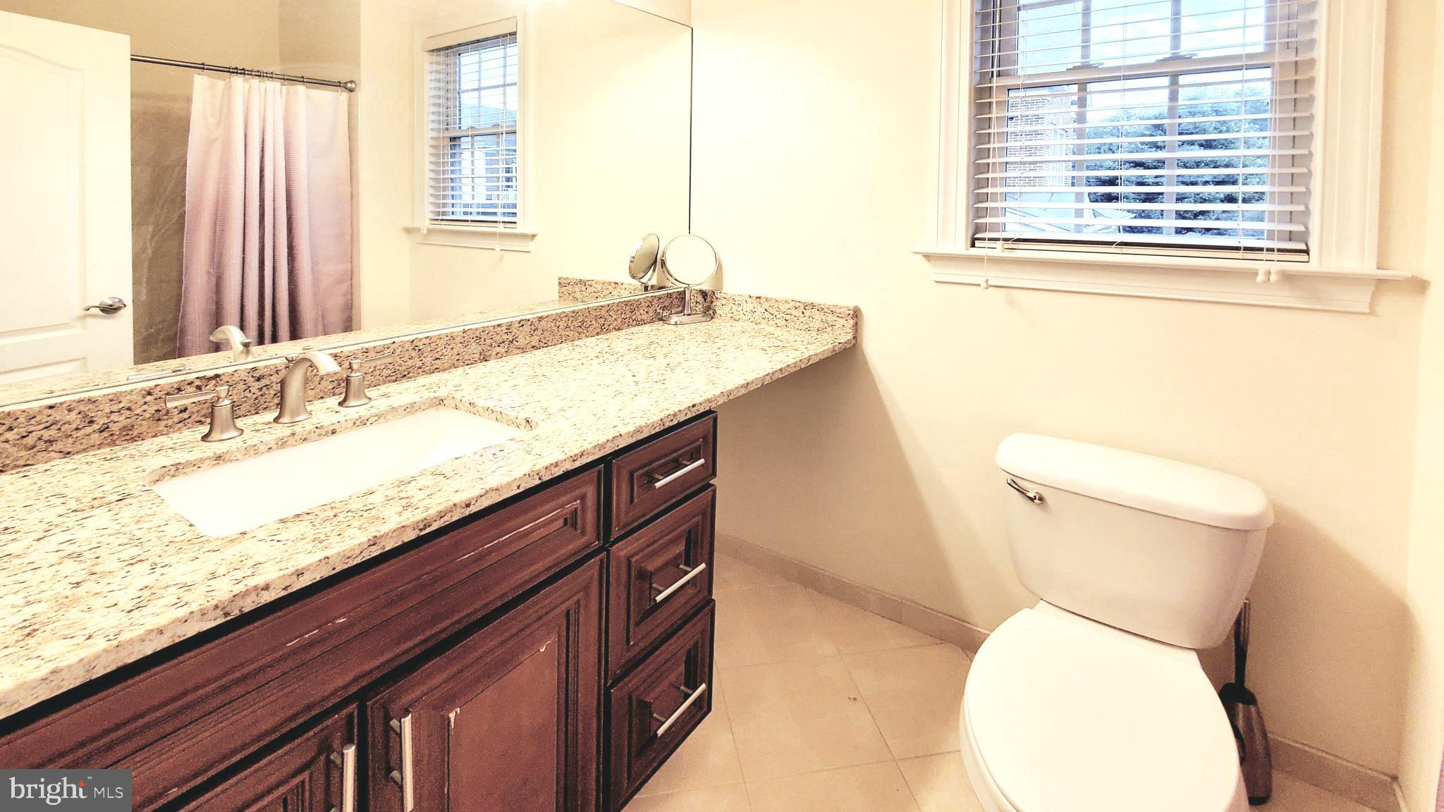 12614 Winter Wren Court Herndon, VA 20171 - Photo 47 of 55 a bathroom with a granite countertop toilet sink and mirror