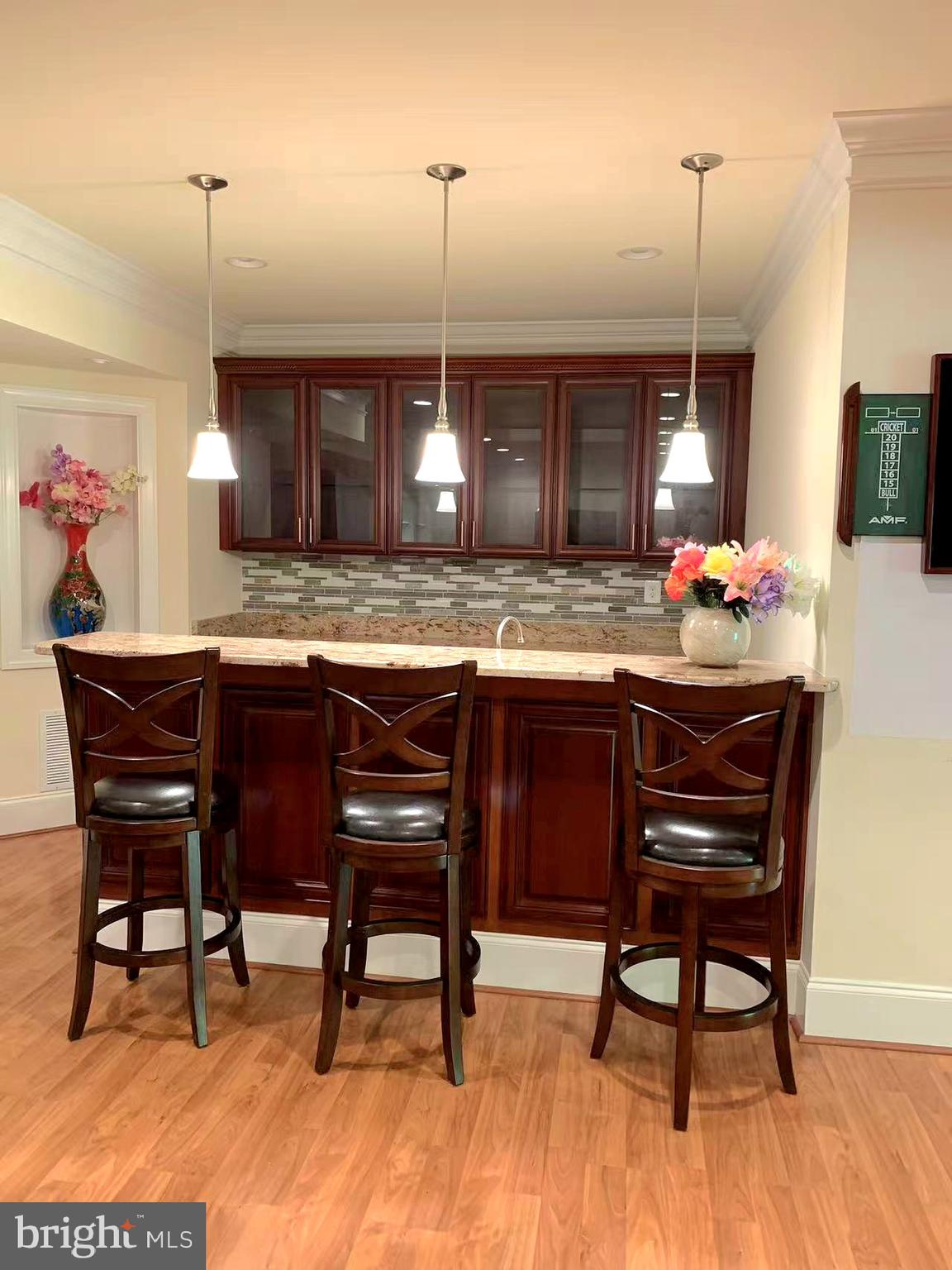 12614 Winter Wren Court Herndon, VA 20171 - Photo 52 of 55 a kitchen with a wooden table and chairs