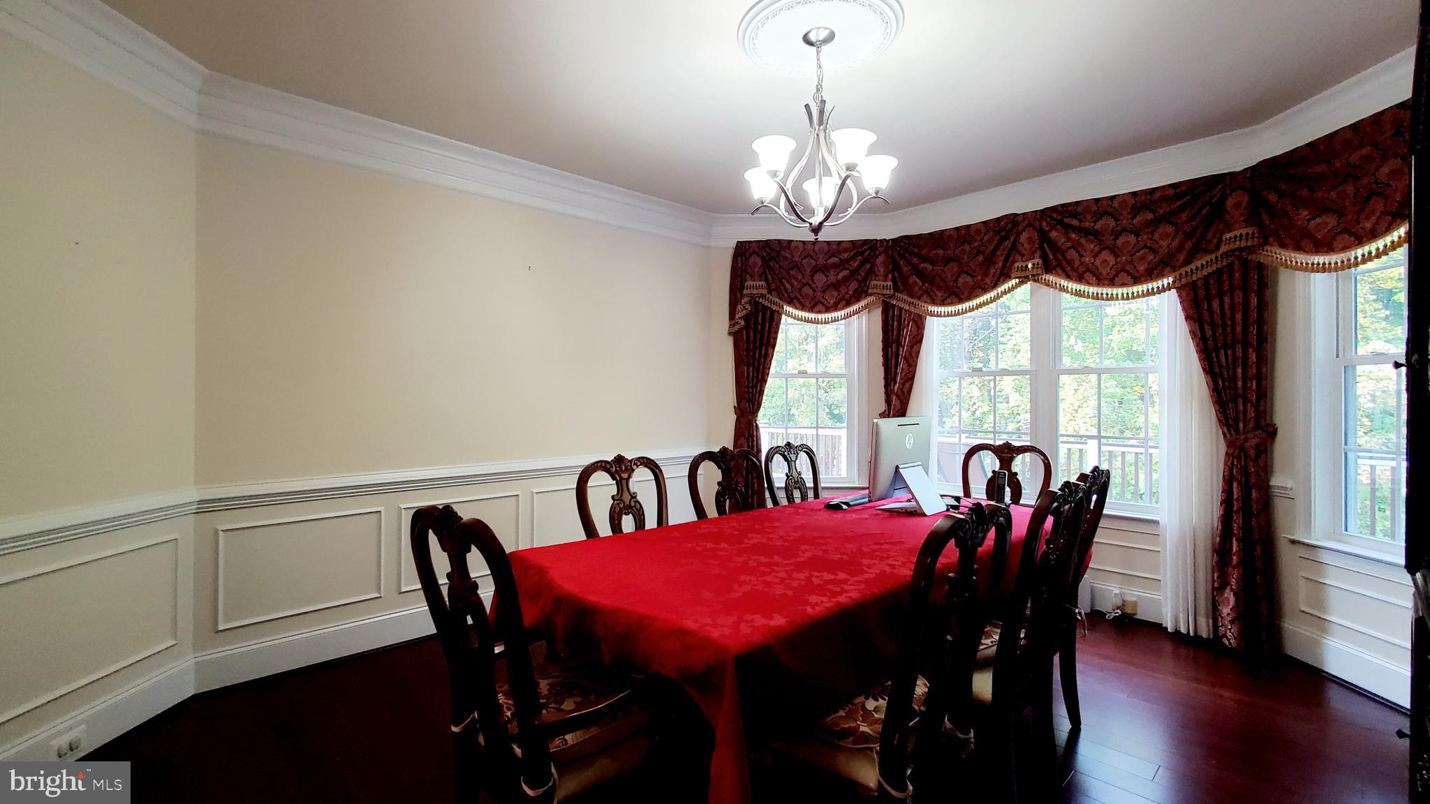 12614 Winter Wren Court Herndon, VA 20171 - Photo 9 of 55 a view of a dining room with furniture window and wooden floor