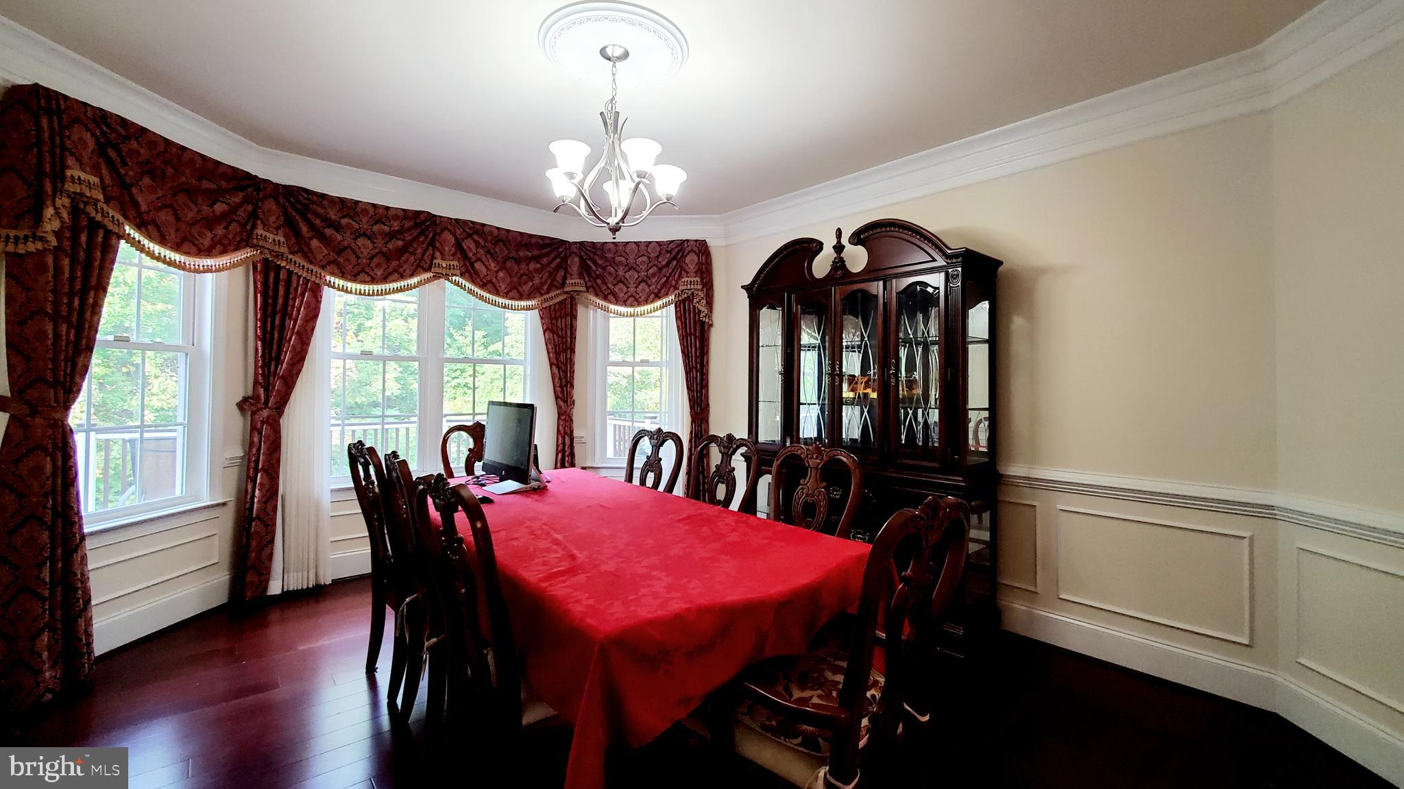 12614 Winter Wren Court Herndon, VA 20171 - Photo 10 of 55 a view of a dining room with furniture window and wooden floor
