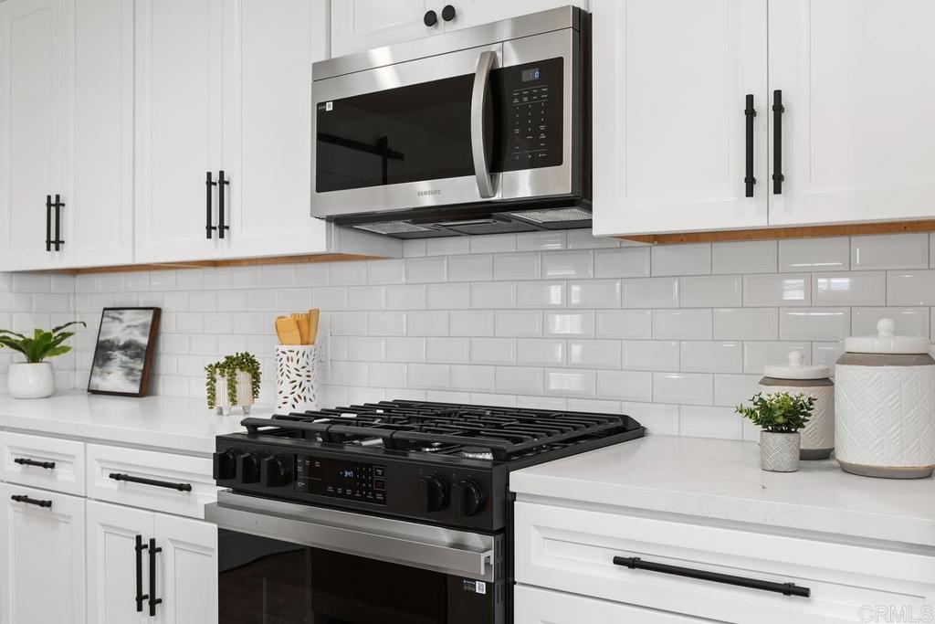 7144 Santa Rosa Carlsbad, CA 92011 - Photo 12 of 41 a stove top oven sitting inside of a kitchen