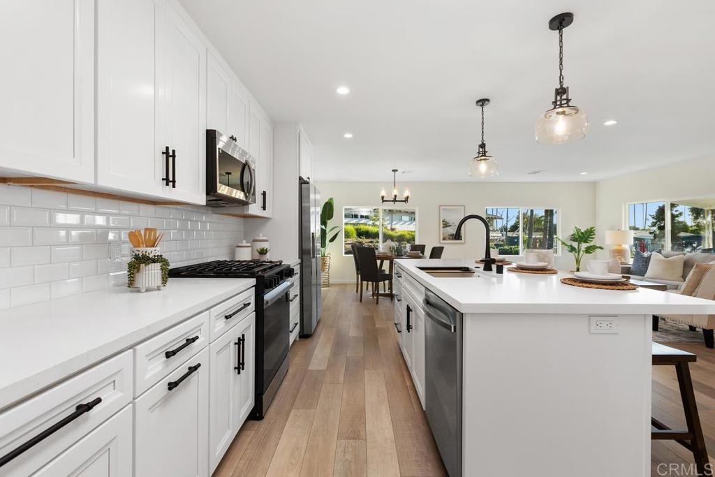 7144 Santa Rosa Carlsbad, CA 92011 - Photo 13 of 41 a kitchen with cabinets a sink and appliances