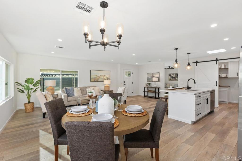 7144 Santa Rosa Carlsbad, CA 92011 - Photo 15 of 41 a large kitchen with a table and chairs