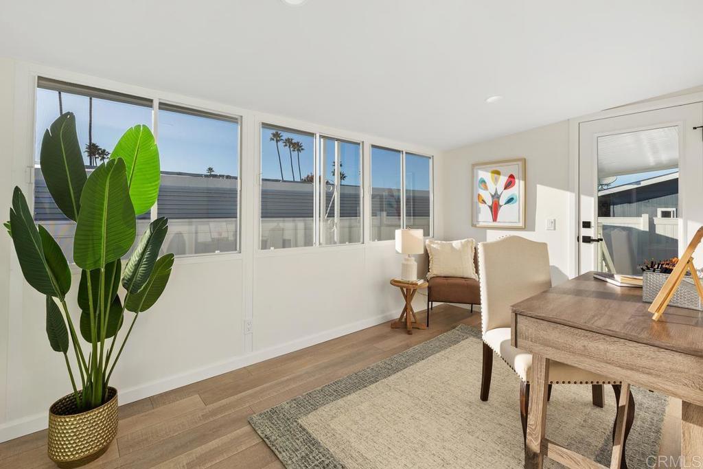 7144 Santa Rosa Carlsbad, CA 92011 - Photo 18 of 41 a living room with furniture a potted plant and a wooden floor