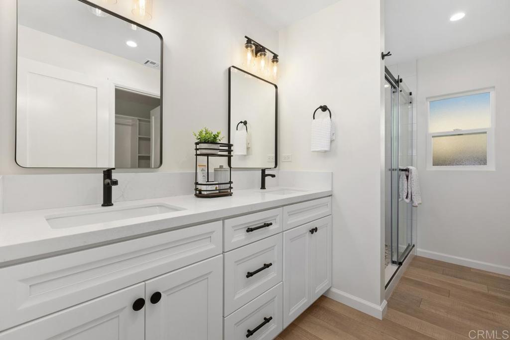 7144 Santa Rosa Carlsbad, CA 92011 - Photo 23 of 41 a bathroom with a double vanity sink mirror and shower