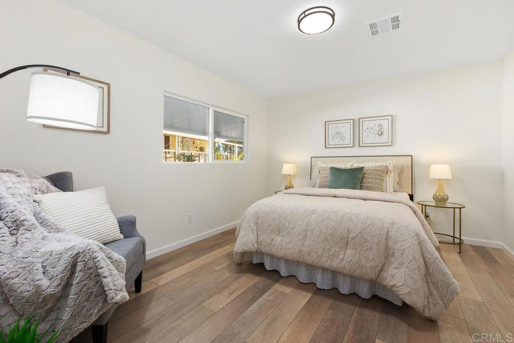 7144 Santa Rosa Carlsbad, CA 92011 - Photo 27 of 41 a bedroom with a bed and a lamp