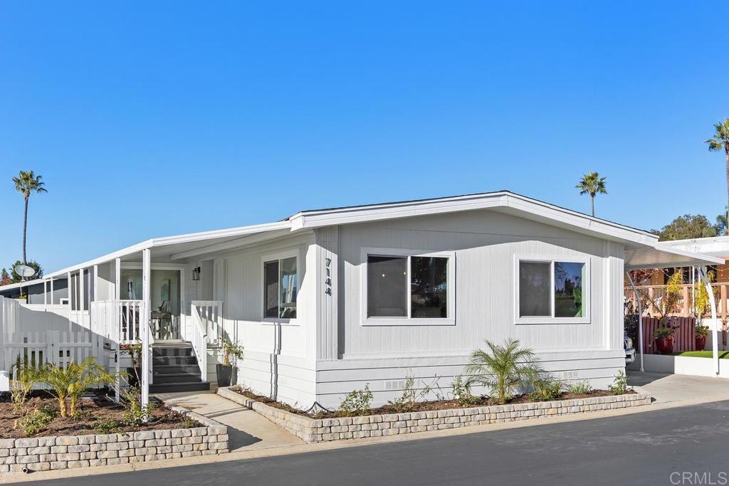 7144 Santa Rosa Carlsbad, CA 92011 - Photo 40 of 41 a front view of a house with a garden