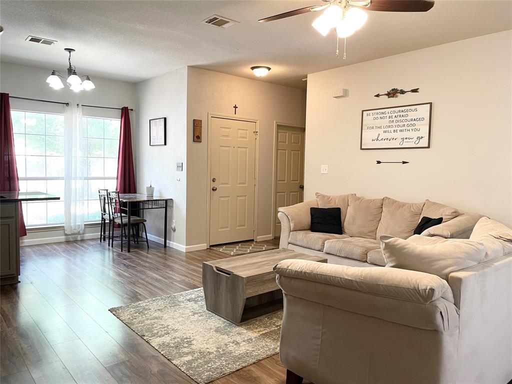 207 Kates Way Hutto, TX 78634 - Photo 18 of 24 Open concept living area featuring wood-finish flooring