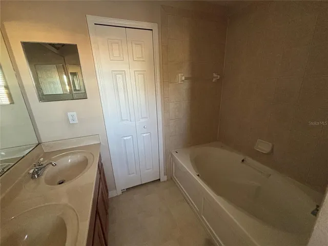 a bathroom with a tub and a sink