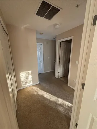 a view of an empty room and a window