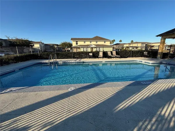 a view of a swimming pool with an outdoor seating